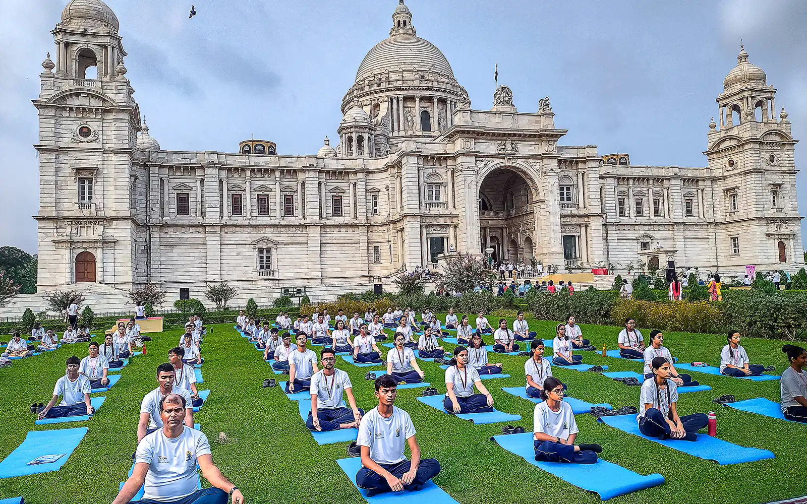 Participants seated cross-legged on yoga mats at an International Day of Yoga event at the Victoria Memorial, Kolkata